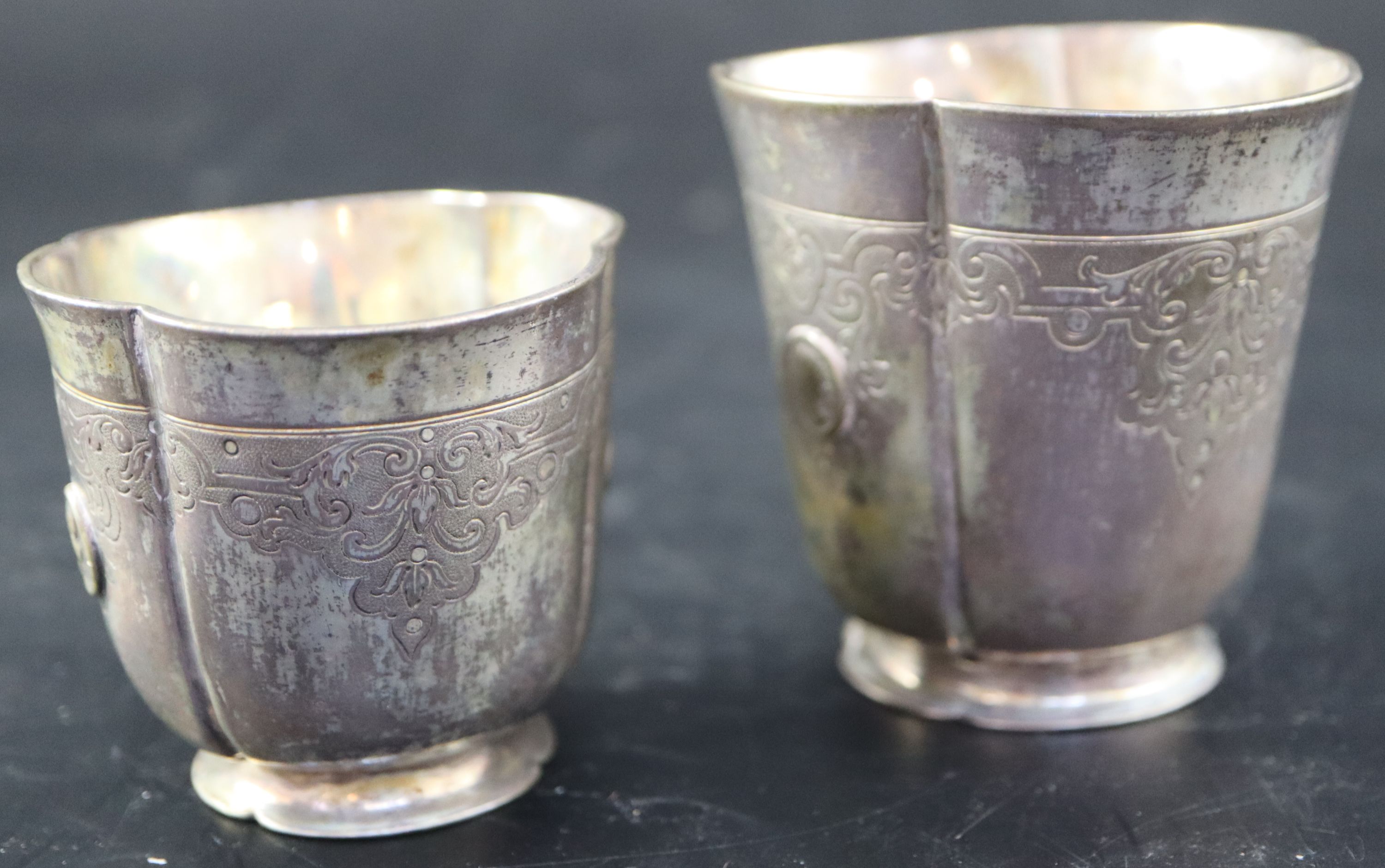 A graduated pair of Continental white metal cusped small vases, tallest 7cm, 215 grams